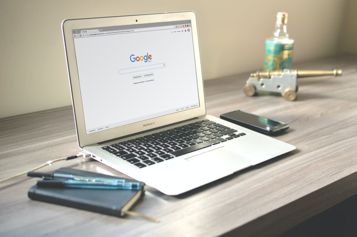 A Macbook Air displaying the Google Search Bar